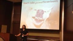 Speaker presenting at WordCamp Miami 2013 with motivational slide reading "Don't take yourself to seriously" displayed on projection screen.