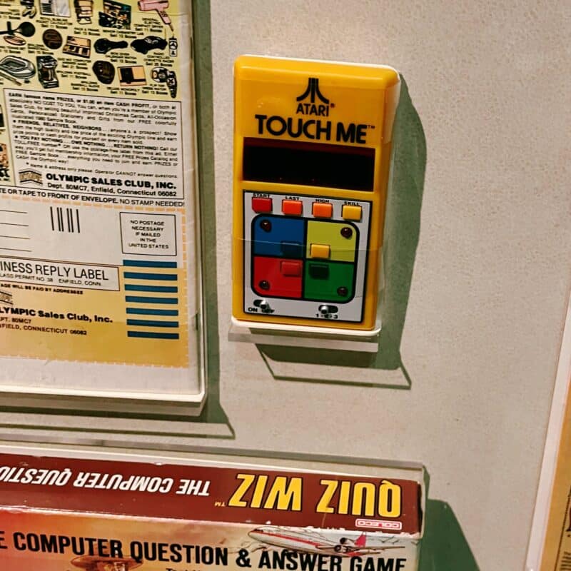 An Atari electronic gaming device that says "Touch Me"