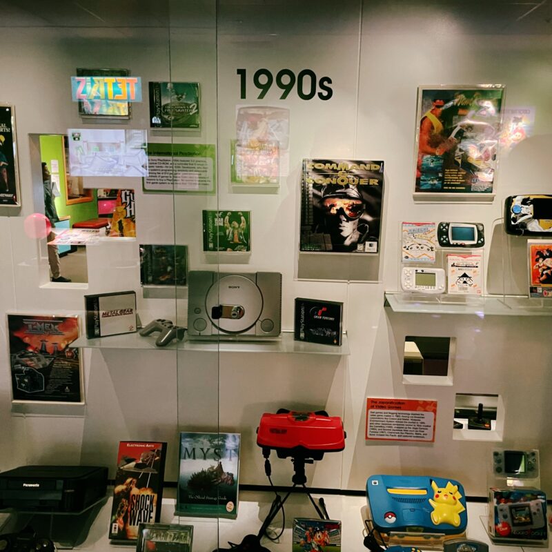 A display of video game consoles from the 1990s