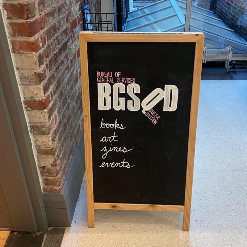 A chalkboard sign for the Bureau of General Services Queer Division in NYC
