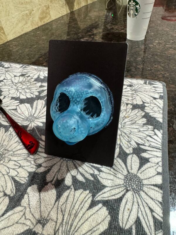 a 3D print of a fursuit head, smaller than full scale. It is on a printer base
