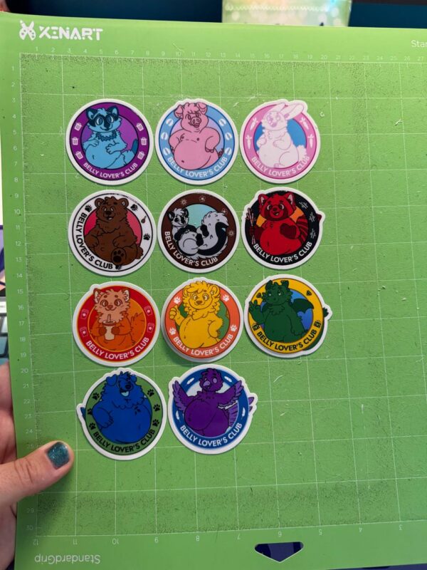 11 stickers on a cutting mat, cut out in their shapes. The stickers are part of the Belly Lover's Club line