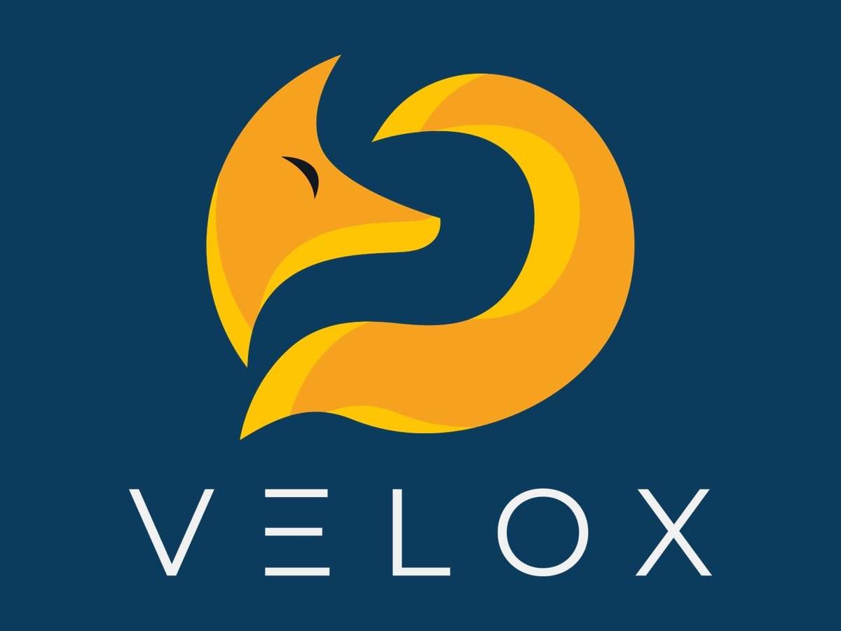 Velox logo featuring a stylized yellow and orange fox head on a dark blue background.
