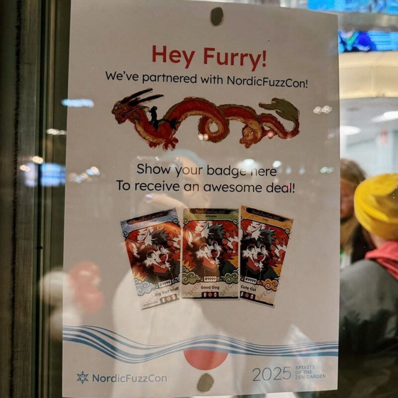 The image shows a poster displayed on a glass window. The top text reads, Hey Furry! We've partnered with NordicFuzzCon! A red and orange dragon illustration separates the main text, and underneath it, the poster instructs, Show your badge here to receive an awesome deal! Three illustrated badges are displayed at the bottom, labeled