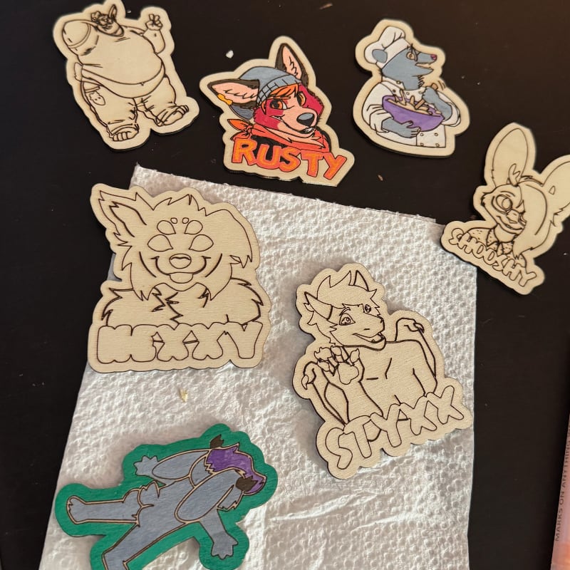 Multiple wooden pins, some just cut, some partially painted.